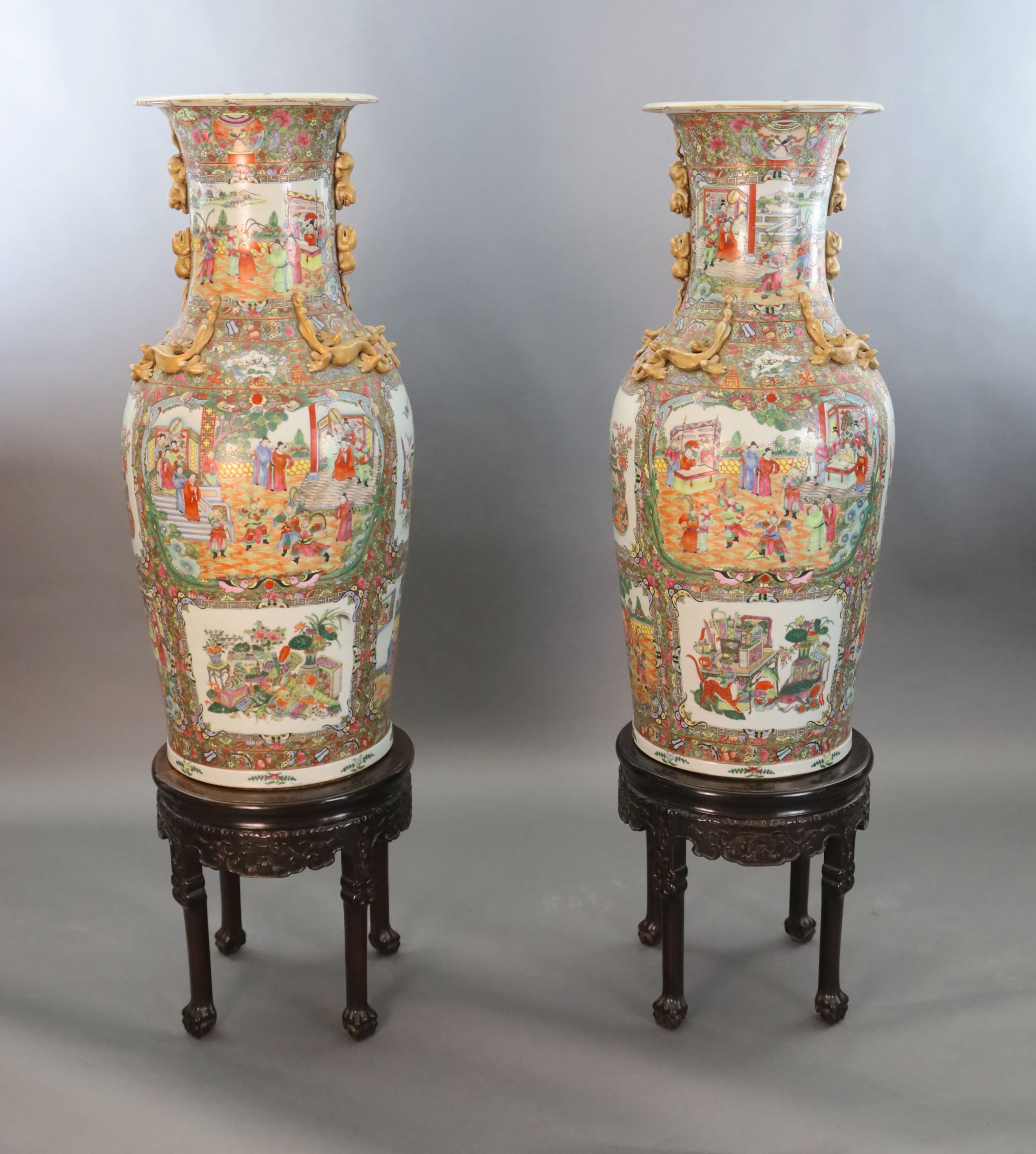 A pair of massive Chinese Canton style famille rose vases, 20th century and a pair of Chinese hongmu and marble stands, late 19th century